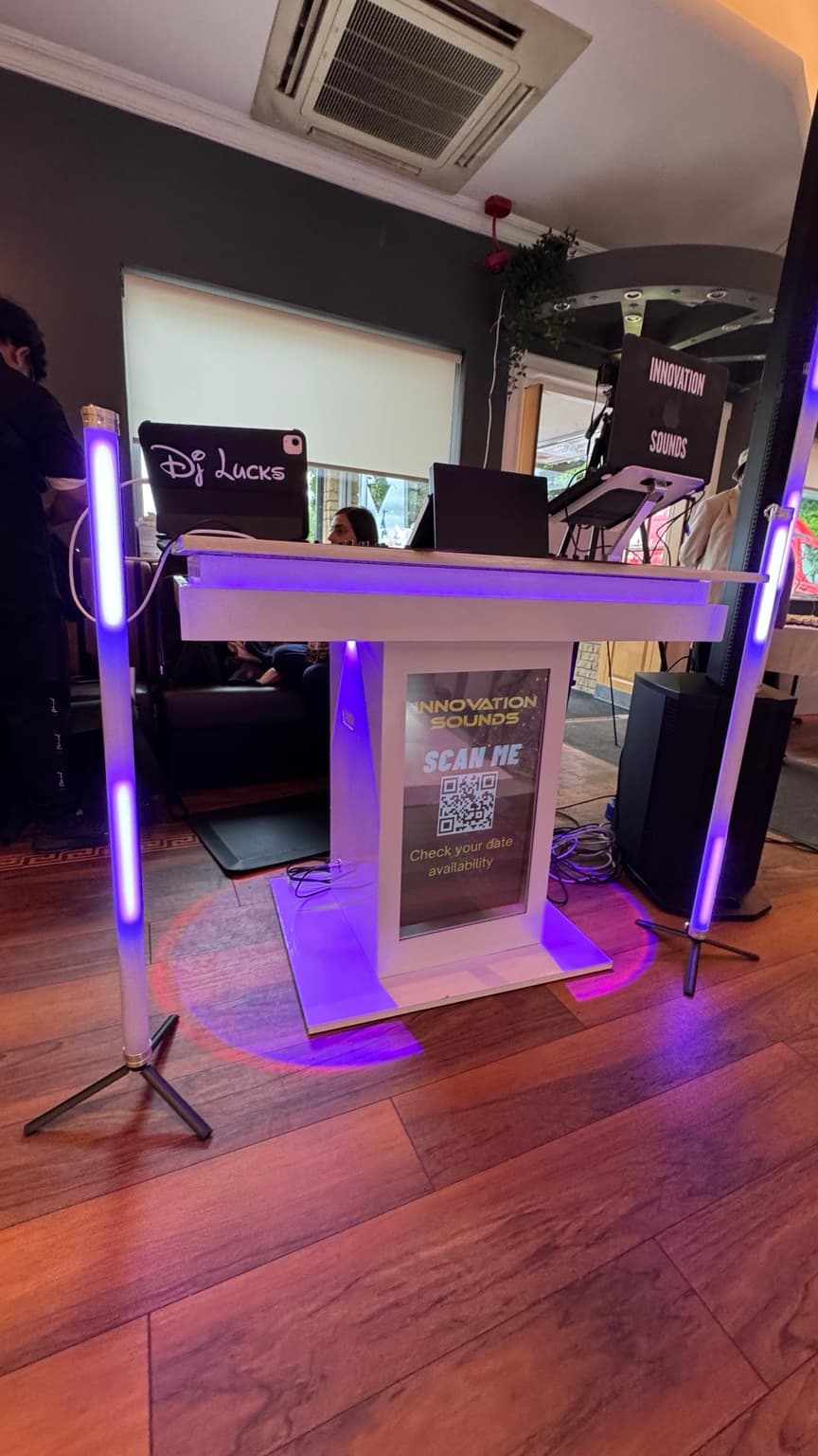 Elegant DJ booth surrounded by floral decor